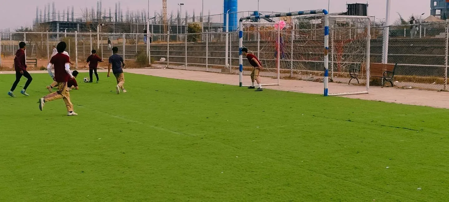 Students playing football near the goal