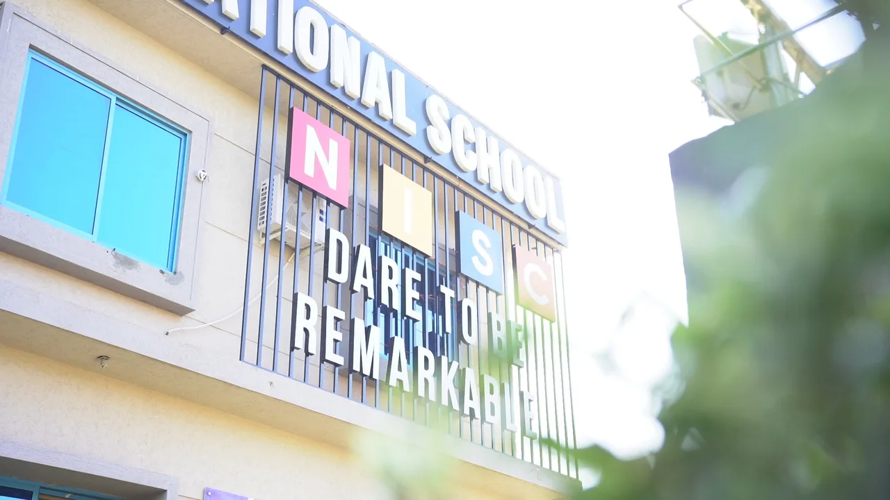 Close exterior view of the Nurture International School building and signage